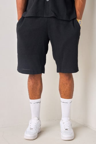 Short noir en tissu texturé et ajouré